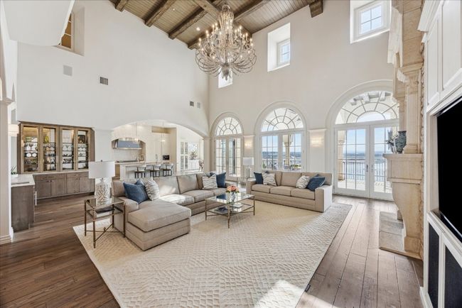 The family room boasts high beamed ceilings, decorative fireplace, wet bar, and stunning views! | Image 9