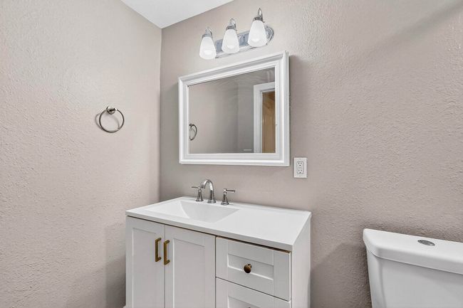 Half bath with vanity and a textured wall | Image 14