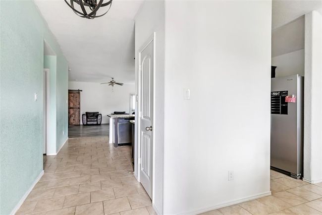 Just inside the front door, the dining room is on the right, with access to the kitchen. And you can see all the way thru to the living room. | Image 8