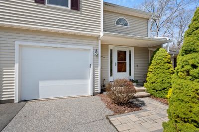 Attached garage and paved driveway with extra parking spaces | Image 2