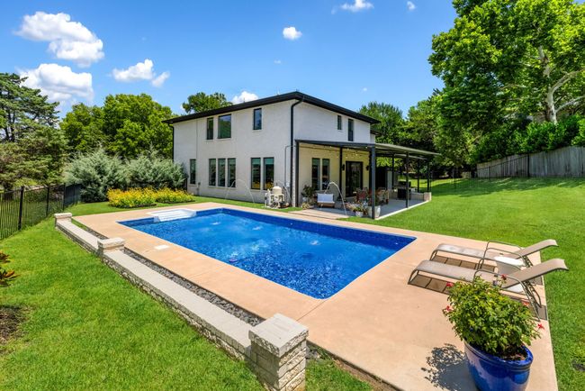 View of pool featuring a patio area and a fenced backyard | Image 33