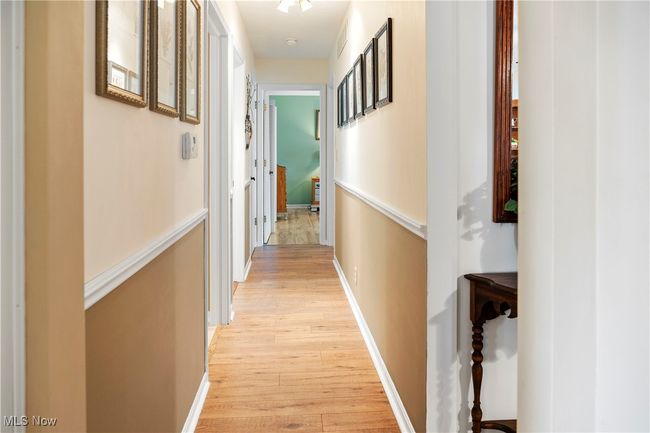 Corridor with baseboards and light wood-style flooring | Image 17