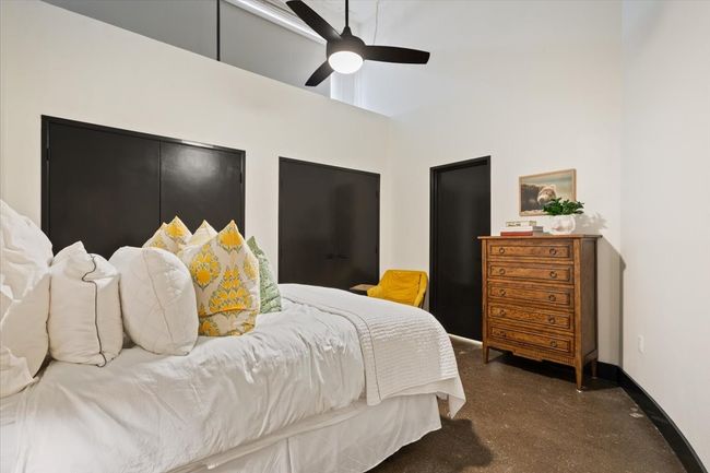 Bedroom featuring a towering ceiling and ceiling fan | Image 11