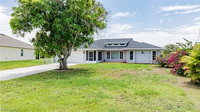 View of front of house featuring a garage and a front lawn | Image 2