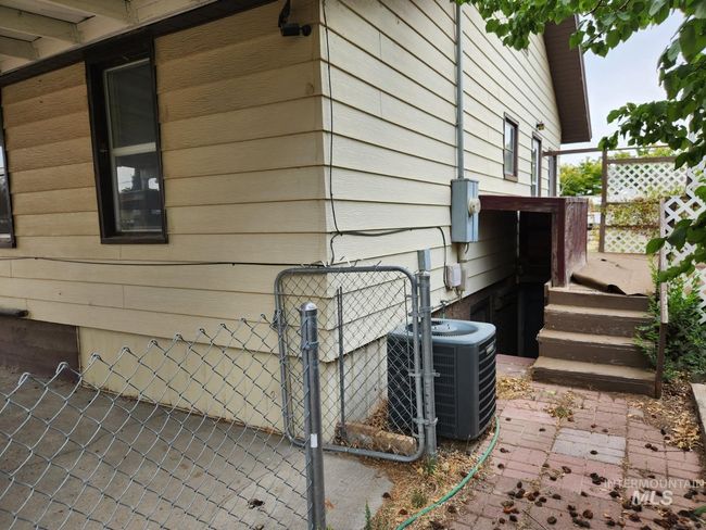 View of property exterior with a gate and a patio area | Image 23