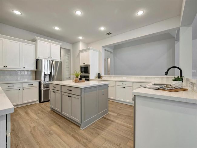 Spacious kitchen with upgraded paint color and backsplash. | Image 8