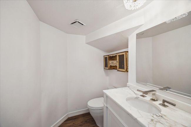 Downstairs 1/2 bath off the hallway with marble counters. | Image 15