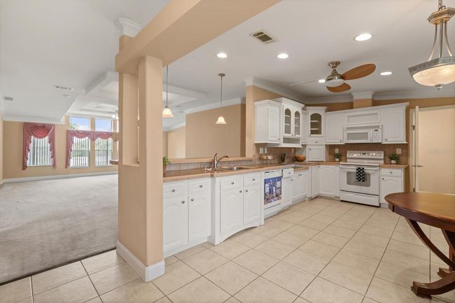 Kitchen with Eating Bar into Living Area | Image 6