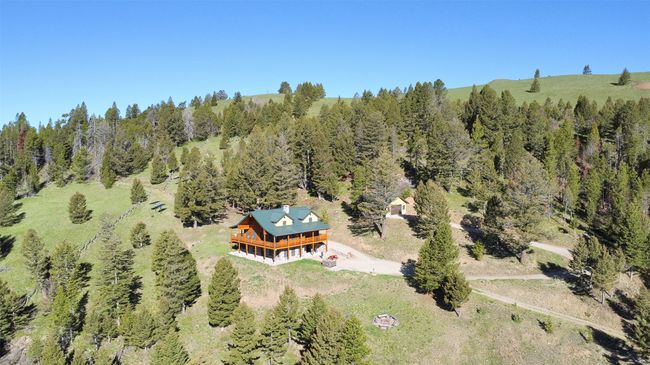 Aerial view of property and surrounding area with a heavily wooded area | Image 70