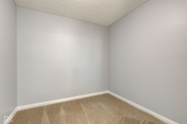 empty room with light colored carpet and a textured ceiling | Image 36