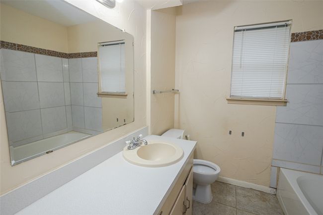 Bathroom 2 with a bath, vanity, and tile patterned flooring | Image 15
