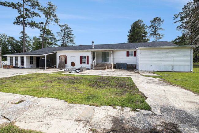 View of front facade featuring a front yard, concrete driveway, and brick siding | Image 27
