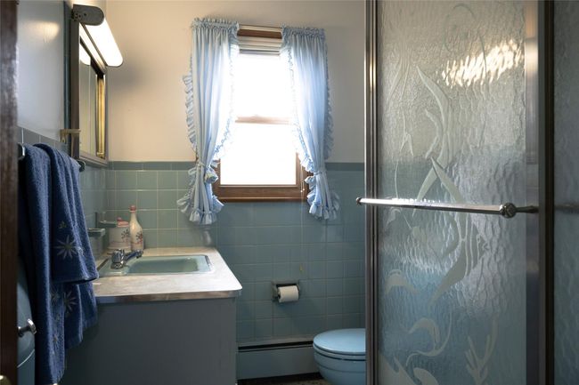 Full bath with tile wainscoting & walls | Image 10