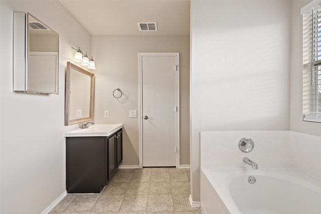 Bathroom featuring vanity and a bath | Image 23