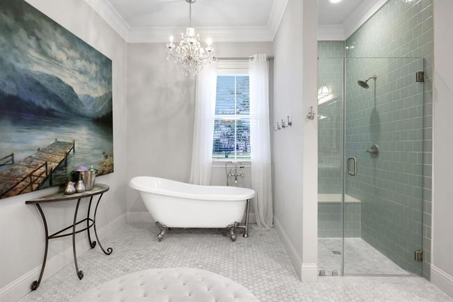 A freestanding soaking tub provides a peaceful escape, while the separate walk-in shower boasts an elegant tile surround and a seamless glass enclosure, completing the upscale, tranquil look. | Image 25