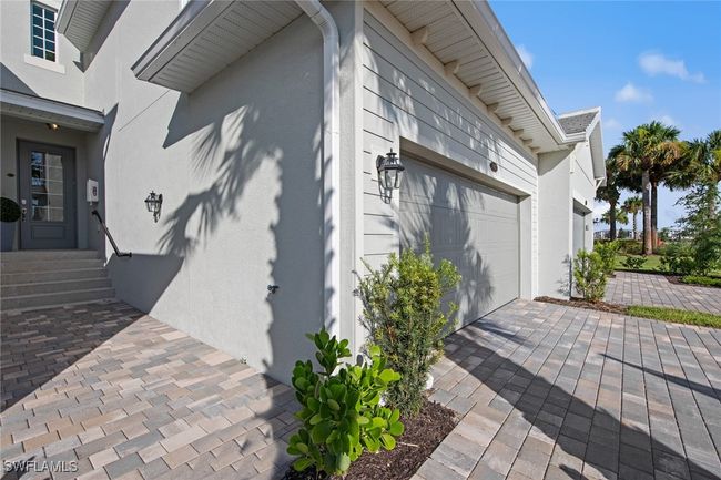 View of side of home with an attached garage and stucco siding | Image 39