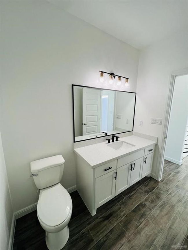 Bathroom featuring vanity, hardwood / wood-style floors, and toilet | Image 16