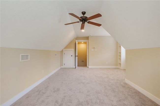 Additional living space featuring lofted ceiling, a ceiling fan, light carpet, and baseboards | Image 15