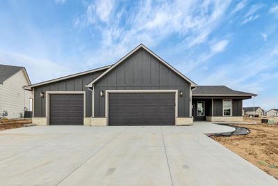 View of front facade featuring a garage and cooling unit | Image 1