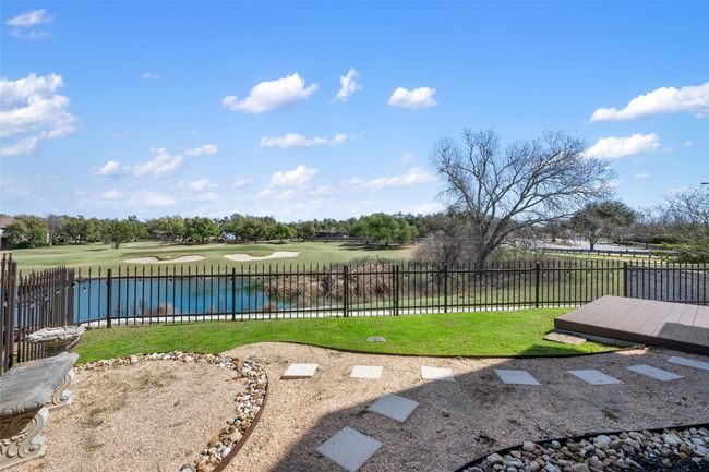 View of yard with a water view, fence, and view of golf course | Image 6