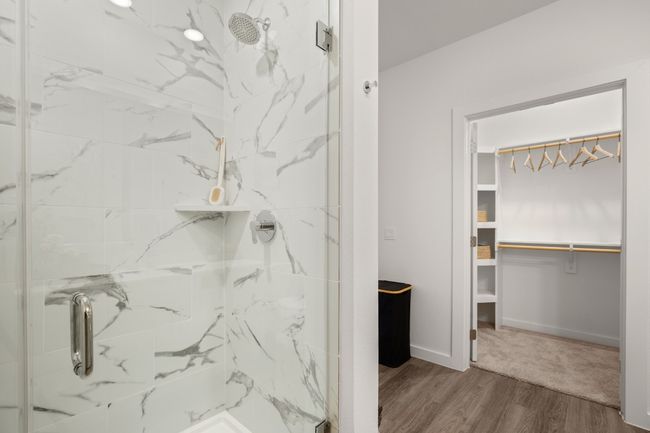 Full bathroom with a modern shower, a walk in closet, and LVP flooring *Photos are of similar unit* | Image 11