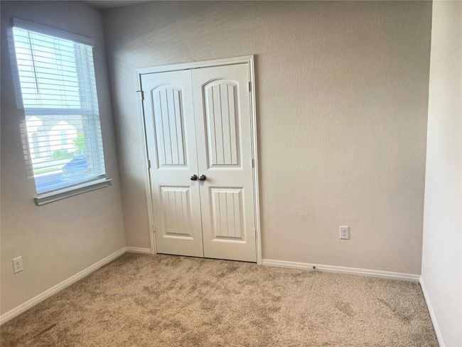 Unfurnished bedroom with carpet flooring, multiple windows, a closet, and baseboards | Image 18