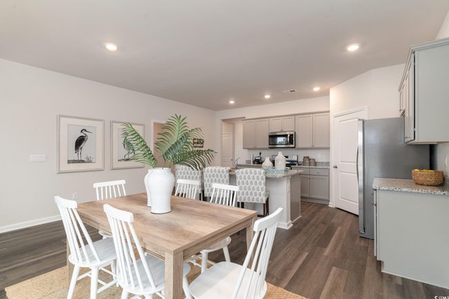 Dining space featuring dark wood finished floors and recessed lighting | Image 10
