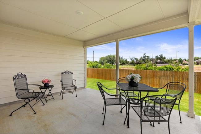 Fenced backyard featuring a patio area and outdoor dining space | Image 32