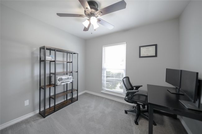 Carpeted office space featuring baseboards and ceiling fan | Image 20