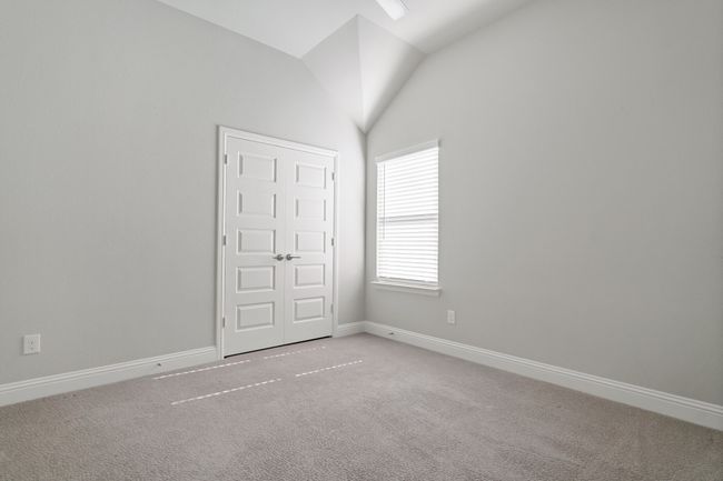 Unfurnished bedroom with baseboards, carpet floors, and vaulted ceiling | Image 25