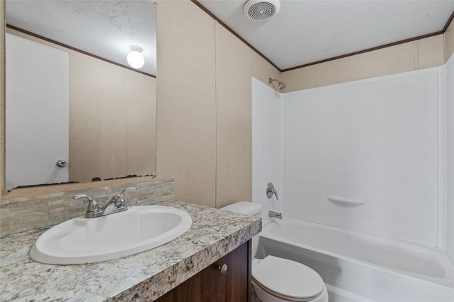 Bathroom with vanity, shower / washtub combination, ornamental molding, and tasteful backsplash | Image 27