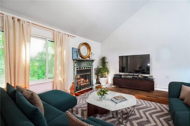 Living room with hardwood / wood-style floors, high vaulted ceiling, and plenty of natural light | Image 4