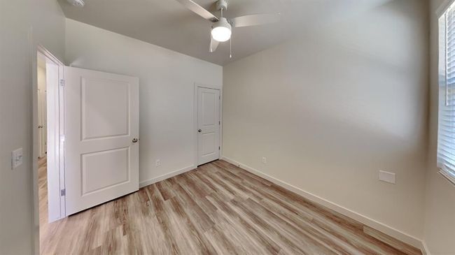 Unfurnished bedroom featuring a ceiling fan, baseboards, and light wood-type flooring | Image 17