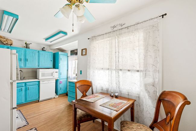 Separate apartment above garage - Dining room featuring light wood-type flooring and ceiling fan | Image 68