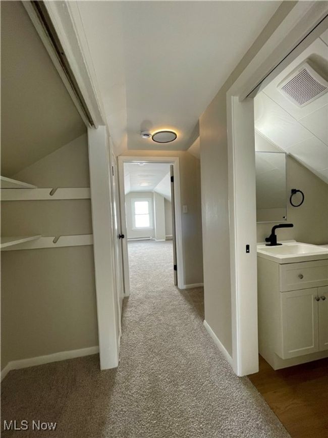Hall featuring lofted ceiling and light carpet | Image 21