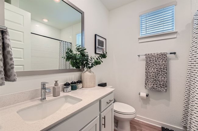 Bathroom with wood finished floors, vanity, baseboards, toilet, and a shower with shower curtain | Image 18