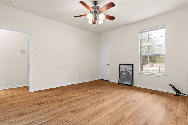 Unfurnished room with light wood finished floors, baseboards, and a ceiling fan | Image 29