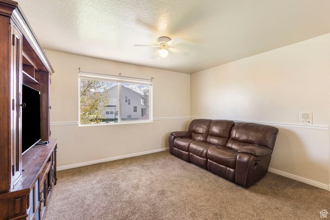 Carpeted living area with baseboards and ceiling fan | Image 21