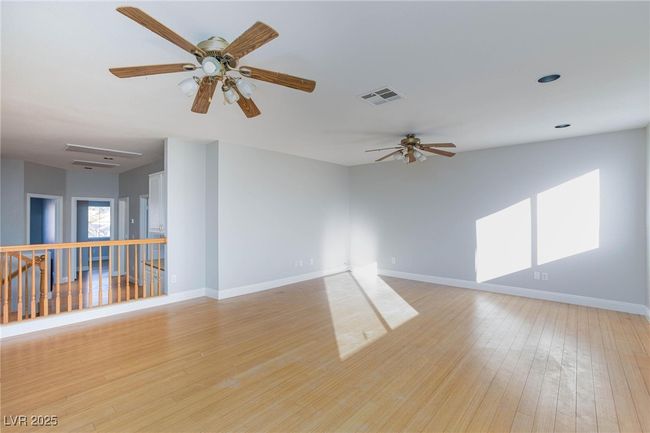 Empty room featuring baseboards, visible vents, light wood-type flooring, and a ceiling fan | Image 22