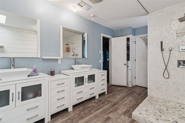 Bathroom with vanity, a tile shower, and wood finished floors | Image 14
