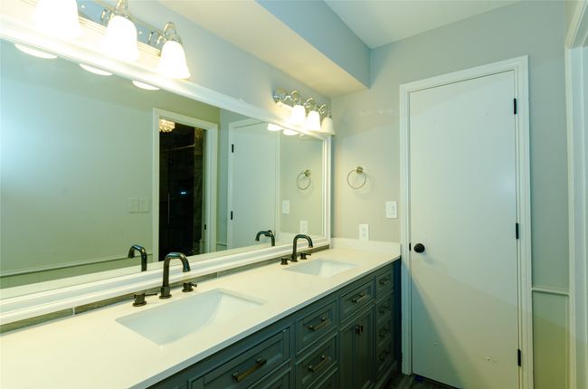 Bathroom featuring double vanity and a shower | Image 19