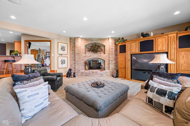 living area featuring recessed lighting and a brick fireplace | Image 71