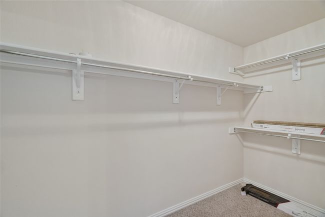 Spacious walk-in closet featuring carpet | Image 22