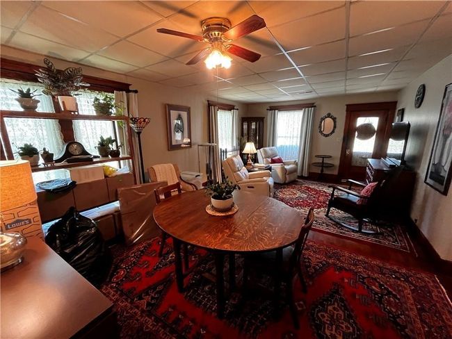 Dining area featuring a paneled ceiling and ceiling fan | Image 10