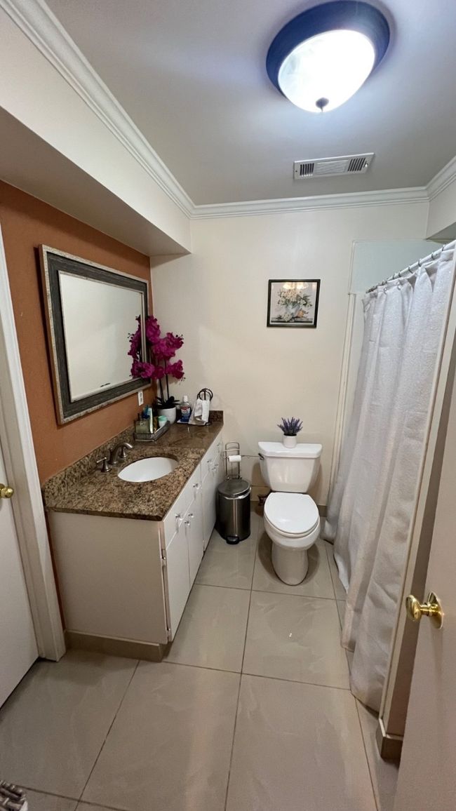 Bathroom featuring ornamental molding, vanity, tile patterned flooring, and a shower with shower curtain | Image 5