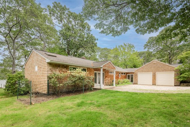 View of front facade with a front yard, an attached garage, driveway, and roof with shingles | Image 4
