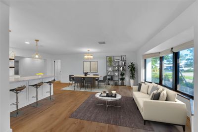 Living room is open and spacious with great space for entertaining guests with dining room, breakfast bar and great natural light | Image 3