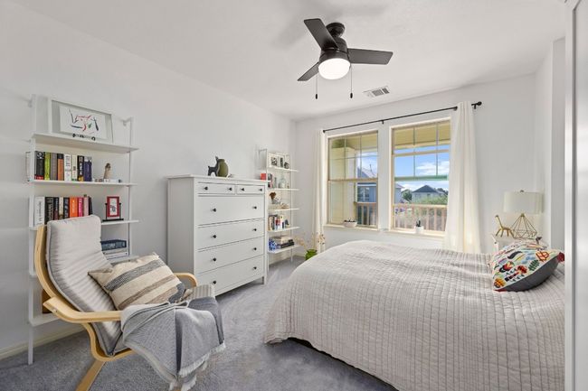 Bedroom with carpet floors, visible vents, and ceiling fan | Image 28