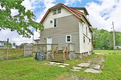 Rear view of property featuring a deck and a yard | Image 3