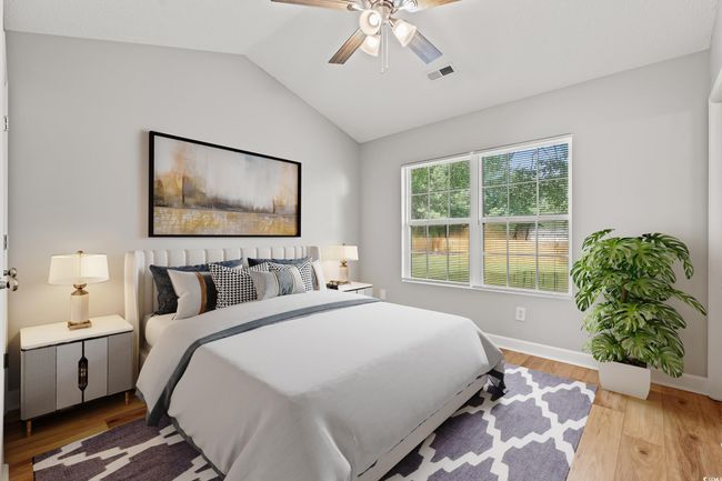 Bedroom featuring vaulted ceiling, light wood-style flooring, and a ceiling fan | Image 14